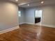 Large bedroom with hardwood floors and an attached bathroom at 119 W Vernon Ave, Wake Forest, NC 27587