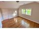 Charming bedroom with hardwood floors, natural light, and neutral paint at 119 W Vernon Ave, Wake Forest, NC 27587