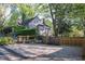 Exterior view of the home features a well-maintained yard and gravel driveway at 119 W Vernon Ave, Wake Forest, NC 27587