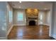 Bright living room featuring a stone fireplace and hardwood floors at 119 W Vernon Ave, Wake Forest, NC 27587