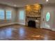 Bright living room featuring a stone fireplace and hardwood floors at 119 W Vernon Ave, Wake Forest, NC 27587