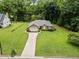 Spacious property with lush greenery, trees, and a well-maintained lawn at 143 Cedarwood Dr, Henderson, NC 27536