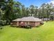 Beautiful backyard with a spacious deck, lush lawn, and mature trees at 143 Cedarwood Dr, Henderson, NC 27536
