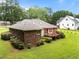 Beautiful brick home with a spacious backyard, wood deck, and mature trees at 143 Cedarwood Dr, Henderson, NC 27536