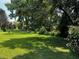 A well maintained lawn is surrounded by mature trees at 143 Cedarwood Dr, Henderson, NC 27536