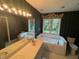 Bright bathroom featuring a large soaking tub and dual vanity sinks at 143 Cedarwood Dr, Henderson, NC 27536