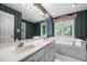 Bathroom featuring a double vanity sink, wallpaper, tub, and a large window at 143 Cedarwood Dr, Henderson, NC 27536