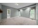 Spacious bedroom featuring three windows with decorative curtains for ample natural light at 143 Cedarwood Dr, Henderson, NC 27536