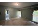 Well-lit bedroom features large windows and ensuite bath for convenience at 143 Cedarwood Dr, Henderson, NC 27536