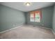 Bedroom showcasing a window with an orange valance, carpet flooring and neutral walls at 143 Cedarwood Dr, Henderson, NC 27536