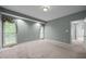 Large bedroom showcasing two windows with decorative curtains, providing natural light at 143 Cedarwood Dr, Henderson, NC 27536
