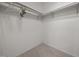 A walk-in closet with basic shelving and carpet flooring for organized storage at 143 Cedarwood Dr, Henderson, NC 27536