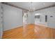 Formal dining room featuring a chandelier, built-in shelving, and hardwood floors at 143 Cedarwood Dr, Henderson, NC 27536
