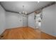 Formal dining room with a chandelier, built-in shelving, wood floors and decorative wall paper trim at 143 Cedarwood Dr, Henderson, NC 27536