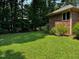 Side yard featuring a brick facade at 143 Cedarwood Dr, Henderson, NC 27536