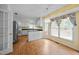 Eat-in kitchen featuring white cabinets, yellow wallpaper, and bright windows, perfect for casual dining at 143 Cedarwood Dr, Henderson, NC 27536