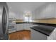 Well-equipped kitchen featuring white cabinets, black countertops, and modern stainless-steel appliances at 143 Cedarwood Dr, Henderson, NC 27536