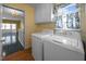 Convenient laundry room area, with a window and adjacent to a hallway at 143 Cedarwood Dr, Henderson, NC 27536