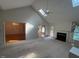 Open living room with skylights, fireplace, ceiling fan, and view of adjoining dining room at 143 Cedarwood Dr, Henderson, NC 27536