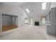 Expansive living room featuring vaulted ceilings, fireplace, built-ins, and seamless transitions to other rooms at 143 Cedarwood Dr, Henderson, NC 27536