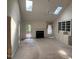 Bright living room features vaulted ceiling, skylights, fireplace, and built in bookshelves at 143 Cedarwood Dr, Henderson, NC 27536