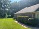 Lush green side yard and stone path surrounding a well maintained home exterior at 143 Cedarwood Dr, Henderson, NC 27536