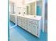 Bathroom featuring a double vanity with modern fixtures and blue flooring at 1500 Prisma Ct, Raleigh, NC 27612