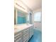 Bathroom featuring a double vanity, mirror, and tub with blue tile surround at 1500 Prisma Ct, Raleigh, NC 27612