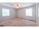 Simple bedroom featuring two windows and a fan at 1500 Prisma Ct, Raleigh, NC 27612