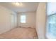 Cozy bedroom featuring neutral carpet, a window, and closet at 1500 Prisma Ct, Raleigh, NC 27612