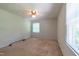 Bedroom with a ceiling fan, neutral carpet, and a window at 1500 Prisma Ct, Raleigh, NC 27612