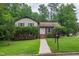 Charming two-story home with landscaped yard, sidewalk, and inviting entrance at 1500 Prisma Ct, Raleigh, NC 27612