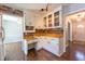 Cozy kitchen featuring white cabinets, wood countertops, and wood backsplash at 1500 Prisma Ct, Raleigh, NC 27612
