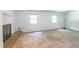 Living room with a brick fireplace and two windows providing natural light at 1500 Prisma Ct, Raleigh, NC 27612