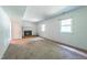 Large living room featuring a brick fireplace, two windows, and carpeted floors at 1500 Prisma Ct, Raleigh, NC 27612