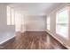Spacious living room featuring lots of natural light and hardwood floors at 1500 Prisma Ct, Raleigh, NC 27612
