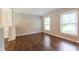 Bright living room featuring two windows and hardwood floors at 1500 Prisma Ct, Raleigh, NC 27612