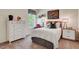 Bright bedroom with a white dresser, decor, large window, and sports-themed wall art at 157 Mildred Pl, Broadway, NC 27505