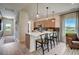 Open kitchen with a breakfast bar, modern pendant lighting, stainless appliances, and hardwood flooring at 157 Mildred Pl, Broadway, NC 27505