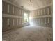 Spacious living room with drywall, unfinished floors, and a bright window at 157 Mildred Pl, Broadway, NC 27505