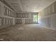 Open concept living room with unfinished flooring, ample lighting, and modern drywall at 157 Mildred Pl, Broadway, NC 27505