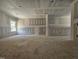 Bright living room featuring unfinished floors, ample lighting, and drywall at 157 Mildred Pl, Broadway, NC 27505
