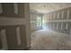 Living room with drywall, unfinished floors, and large windows at 157 Mildred Pl, Broadway, NC 27505