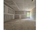 Spacious living room showcasing high ceilings, unfinished walls, and a bright window at 157 Mildred Pl, Broadway, NC 27505