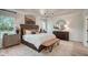 Spacious primary bedroom featuring a tray ceiling, elegant chandelier, and ample natural light at 157 Mildred Pl, Broadway, NC 27505