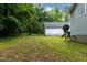 Large, grassy backyard with mature trees, offering a private and serene outdoor space at 180 Normandy Rd, Louisburg, NC 27549