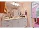 Bathroom vanity area with a large mirror, ample counter space, and natural lighting at 180 Normandy Rd, Louisburg, NC 27549