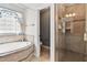 Bathroom featuring a soaking tub and a separate shower with glass door at 180 Normandy Rd, Louisburg, NC 27549