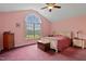 Charming bedroom featuring vaulted ceilings and a large arched window with tranquil outdoor views at 180 Normandy Rd, Louisburg, NC 27549