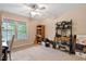 Bright bedroom with a ceiling fan and a large window offering an abundance of natural light at 180 Normandy Rd, Louisburg, NC 27549